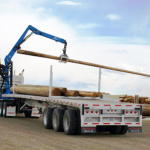 Adams-industries-truck-loading-wood-logs-our-company